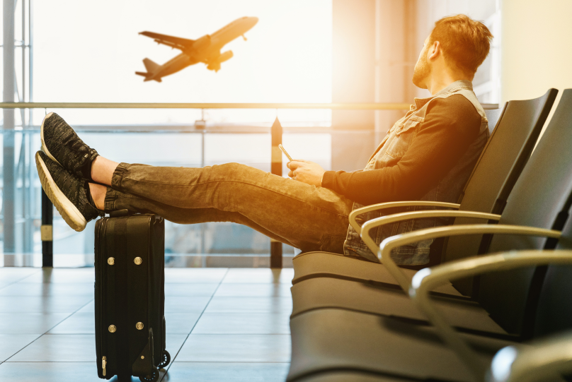 a man sitting on a chair in an airport